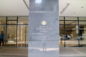 A modern building entrance with a sign reading "Eastwood Legrand Tower 3".