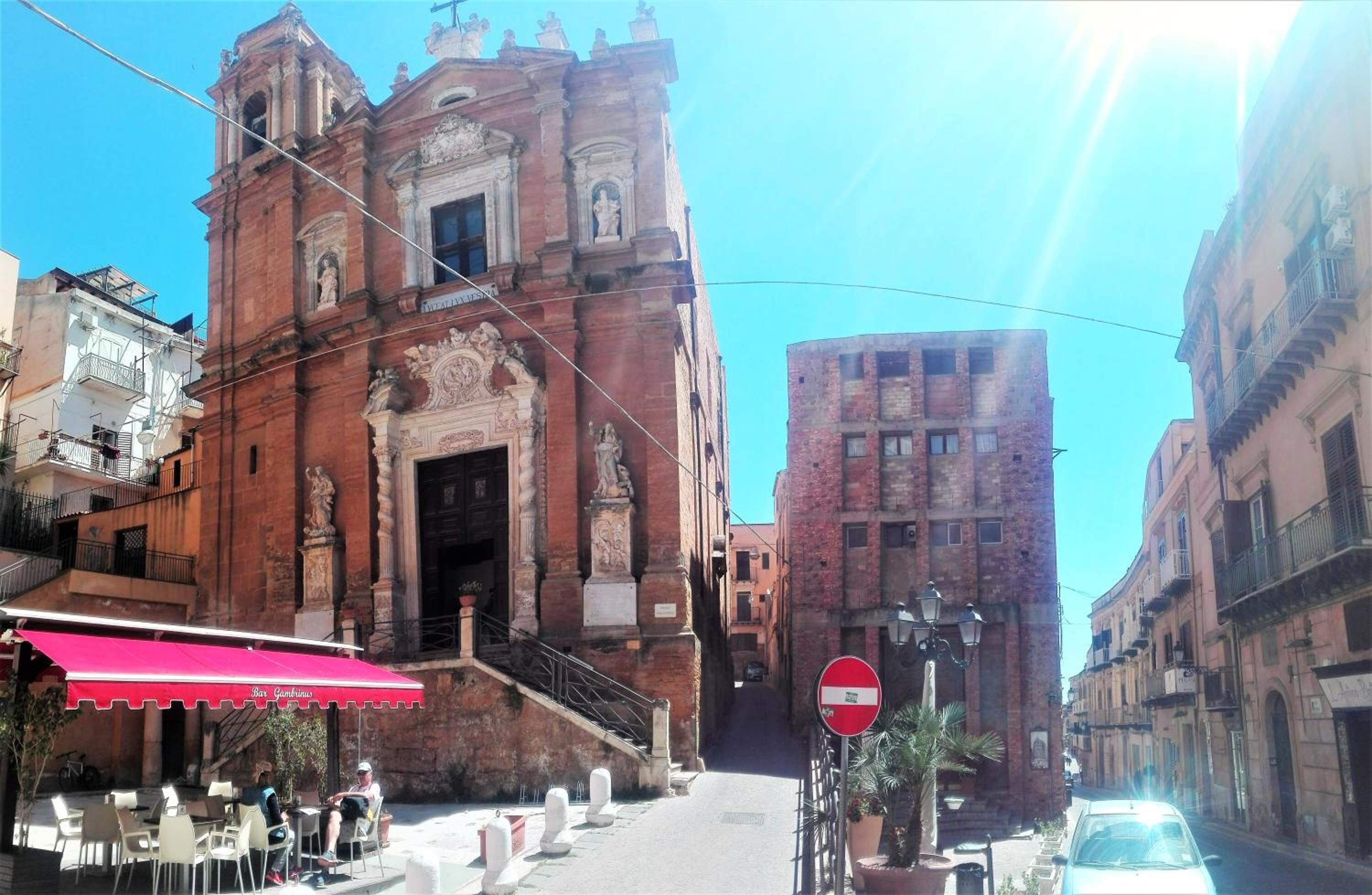 A historic building with a prominent entrance and a staircase leading up to it.
