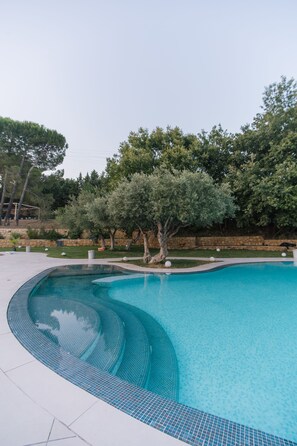 2 utendørsbassenger og solsenger