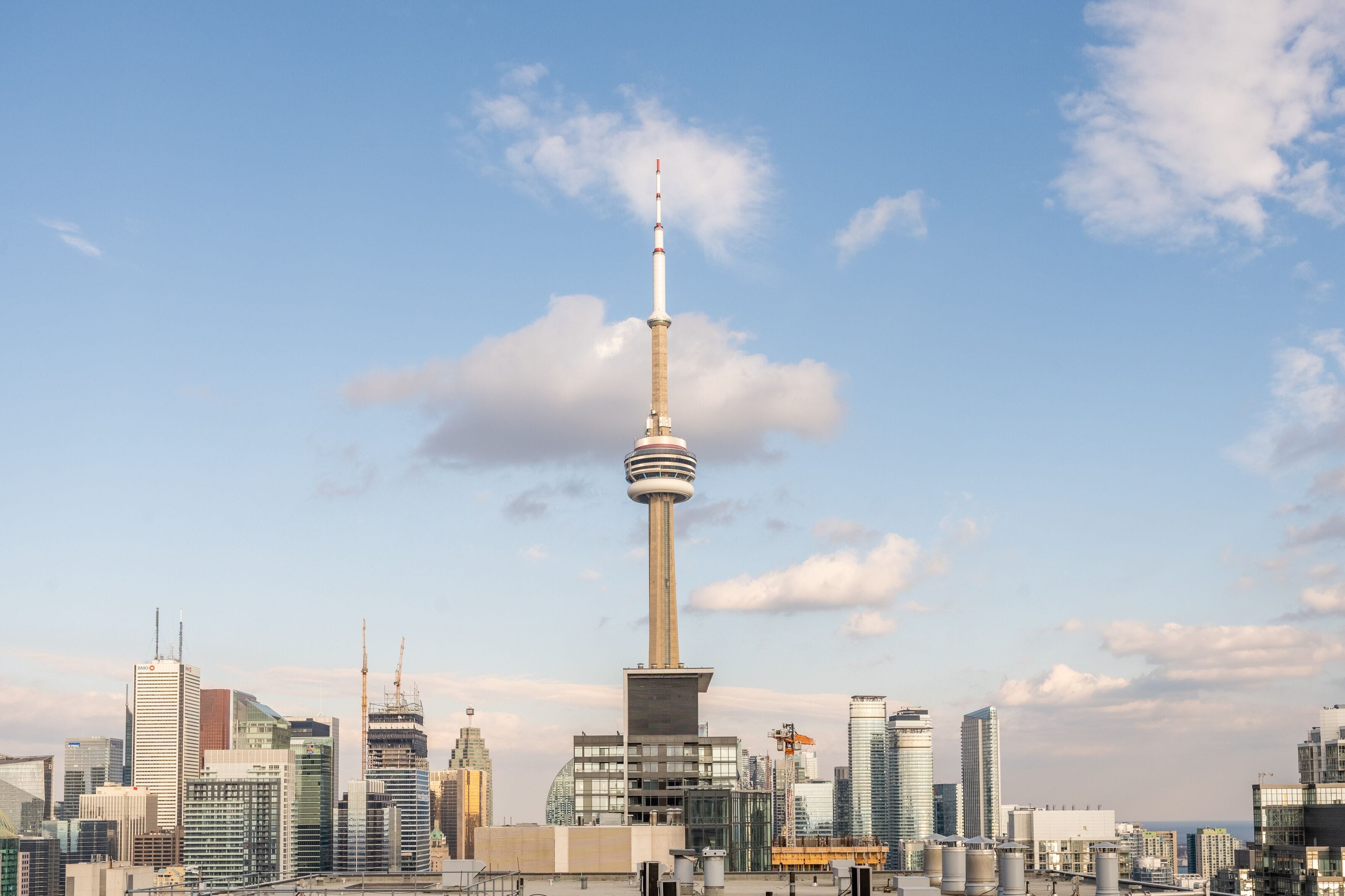 A cityscape with a prominent tower and modern buildings.