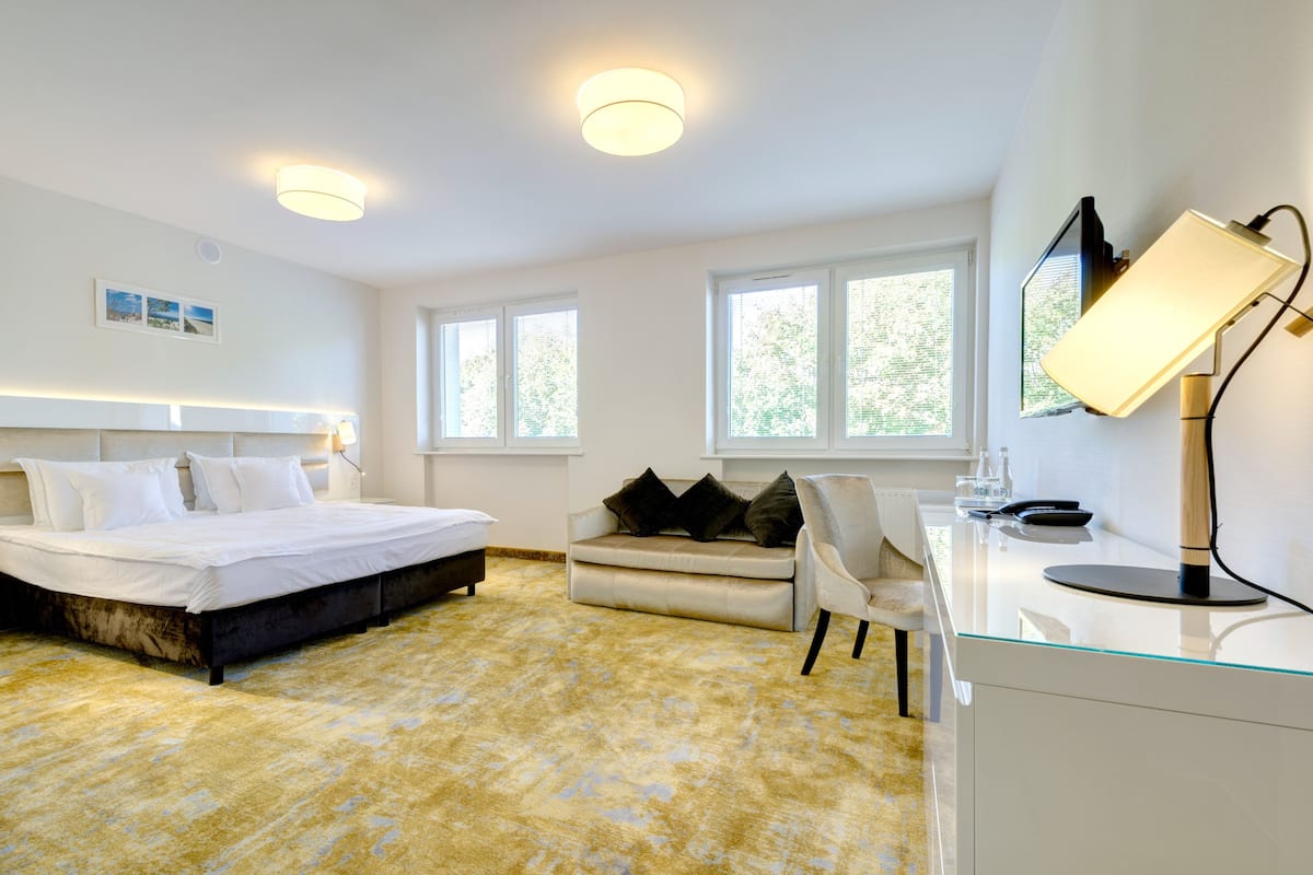 family room | in-room safe, desk, blackout curtains, iron/ironing board