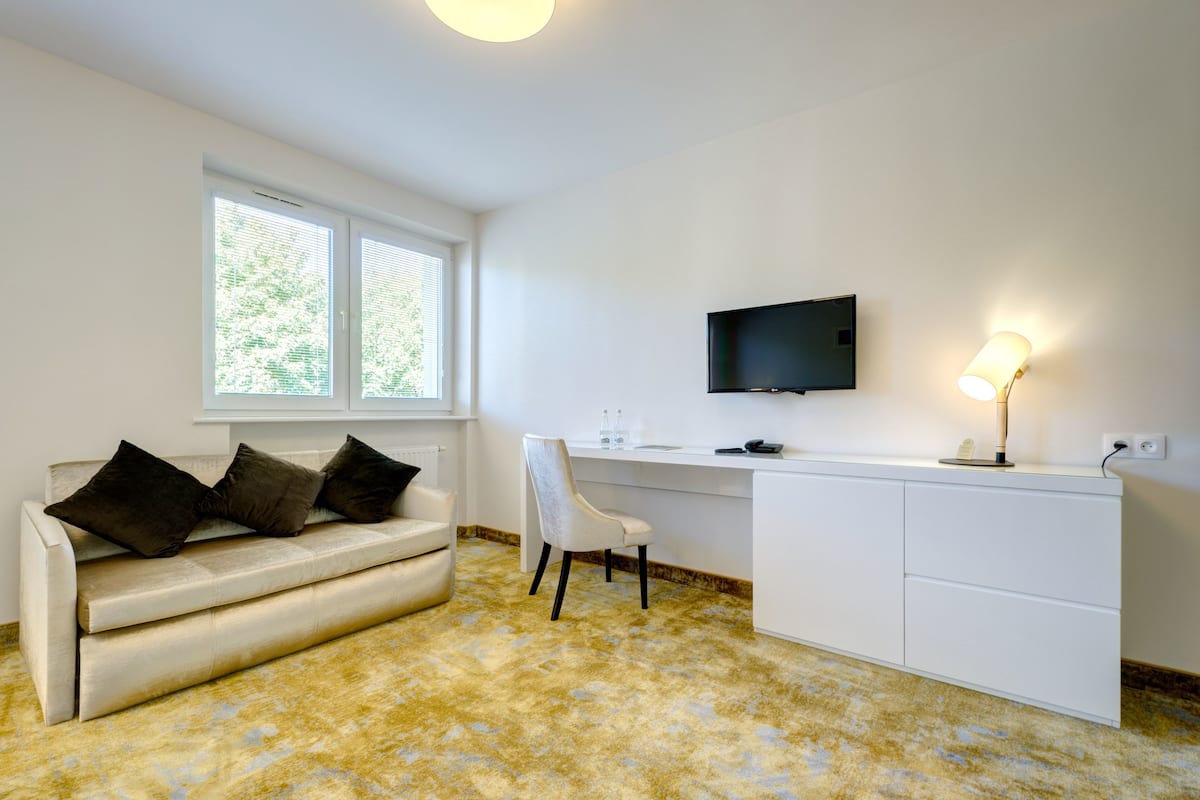 family room | in-room safe, desk, blackout curtains, iron/ironing board