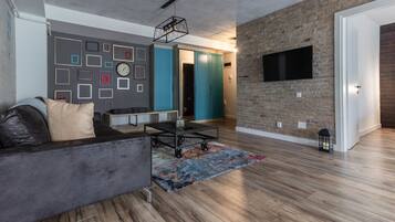 Exclusive Apartment | Living area | 108-cm Smart TV with digital channels, TV, books