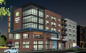 A modern hotel with a prominent 'Holiday Inn Express' sign, multiple floors, and a covered entrance area. - Holiday Inn Express & Suites Charlotte - South End by IHG (Charlotte)