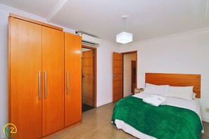 Comfortable accommodations feature a spacious bed and ample storage in a large wardrobe.