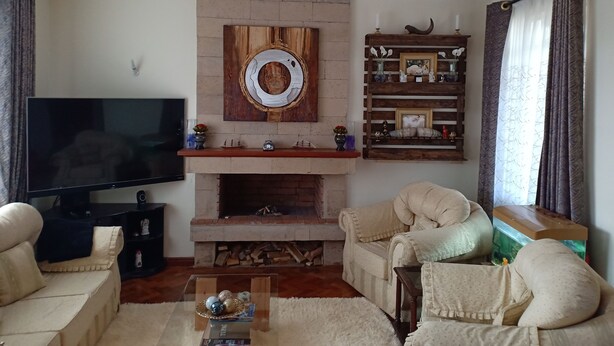 A living room with a fireplace, television, and comfortable seating.