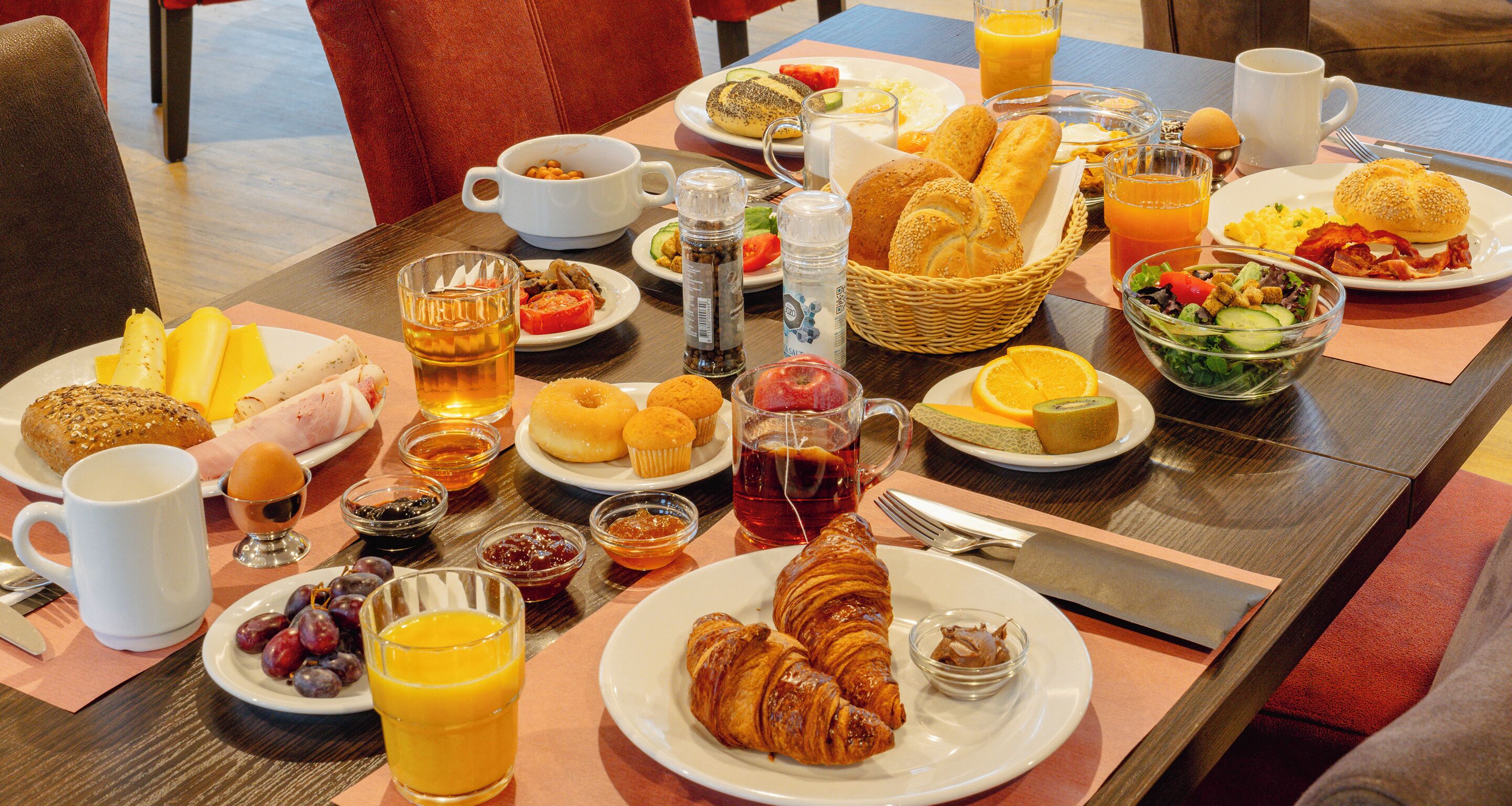 A breakfast buffet with various food items and beverages.