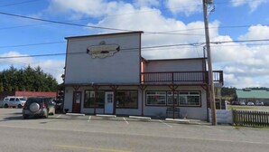A two-story building with a large sign on the front. - Tyee Restaurant and Hotel (Coupeville)