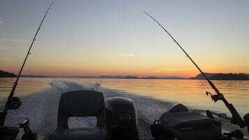 A boat with two fishing rods, a Yamaha outboard motor, and a wakeboard.
