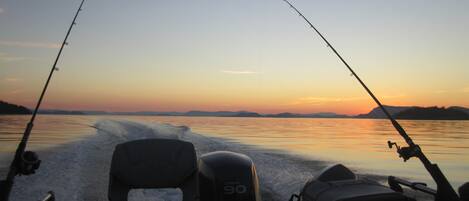 A boat with two fishing rods, a Yamaha outboard motor, and a wakeboard.