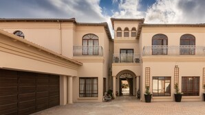 A two-story building with a central entrance, large windows, and a garage. - Amery House (Gqeberha (Port Elizabeth))