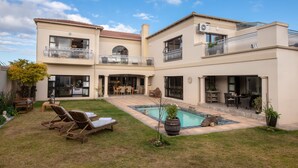 A two-story house with a swimming pool, outdoor seating, and a well-maintained garden. - Amery House (Gqeberha (Port Elizabeth))