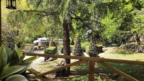 A garden with a wooden deck, stone pathway, and various trees. - Mount Tomah Huntington Lodge - peaceful & picturesque Hamptons styled hideaway  (Mount Tomah)