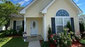 A single-story house with a front porch, a mailbox, and a well-maintained lawn.