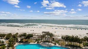 A beach view with a pool and lounge chairs. - Updated W 700 1 Bedroom 2 Bath Gulf Front Condo with Stunning Views! (Pensacola)