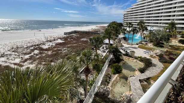 A beachfront hotel with a pool, beach access, and a view of the ocean. - Gulf Front Condo with Stunning Views! (Pensacola)