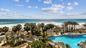 A resort with a swimming pool, beach, and palm trees. - Gulf Front Condo with Stunning Views! (Pensacola)