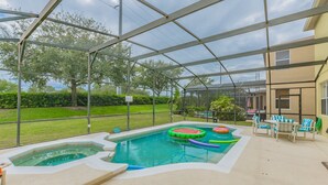 A covered outdoor swimming pool with hot tubs and inflatable water toys. - Renewed luxury property 20 min from Disney and major parks (Davenport)
