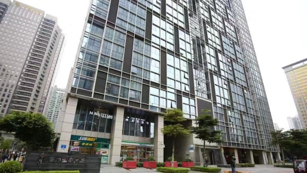 A modern high-rise building with a Subway restaurant on the ground floor. - F&H Apartment Guangzhou Wales Branch (Guangzhou)