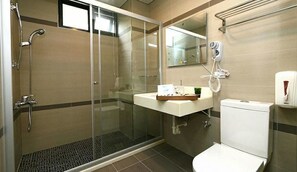 Bathroom features a glass-enclosed shower, sink, and toilet.