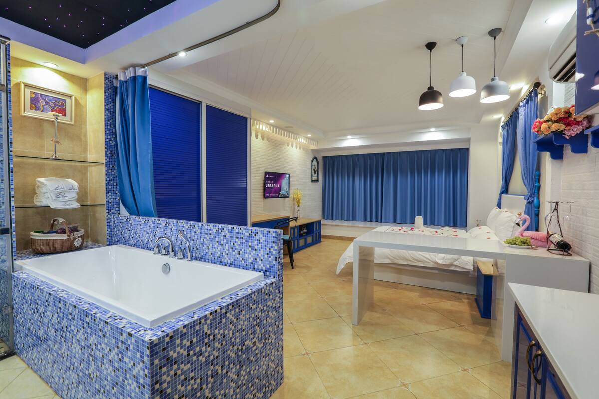A modern bathroom with a large bathtub, a shower area, and a vanity with a mirror.