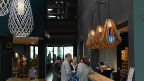 A reception area with a reception desk, hanging pendant lights, and a wall with the word "RECEPTION" visible.