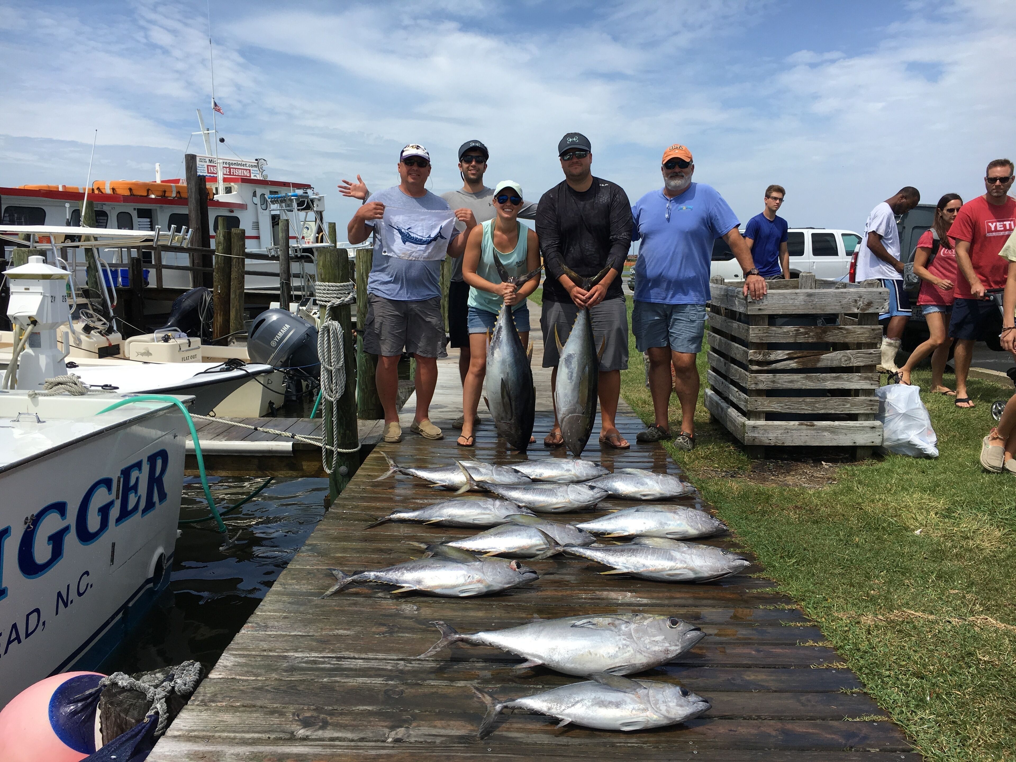 A dock with several fish laid out on the wooden planks.