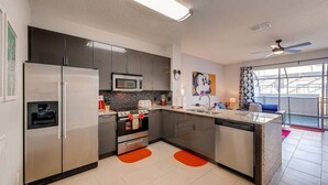 A modern kitchen with stainless steel appliances, a microwave, and a dishwasher. - Windsor Palm Resort/Pool /3 miles to Disney (Kissimmee)
