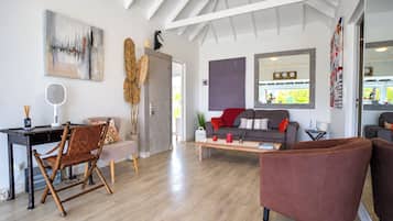 A modern living room with a dining area, a sofa, and a coffee table.