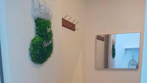 A bathroom with a white sink, a mirror, and a door with a brass handle. - Affordable Condo with FREE WIFI and Amenities (Cebu City)