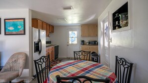 A compact kitchen with wooden cabinets, a refrigerator, a microwave, and a coffee maker. - Hippohead Casita Pets stay free bring your Humans! (Homosassa)