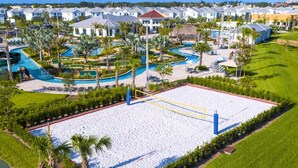 A resort with multiple swimming pools, a large sandy area, and a row of villas. - Family Fun: Condo near Theme Parks & Pools! (Kissimmee)