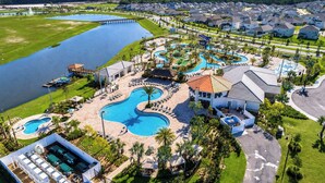 A resort with a large swimming pool, a water park, and a golf course. - Family Fun: Condo near Theme Parks & Pools! (Kissimmee)