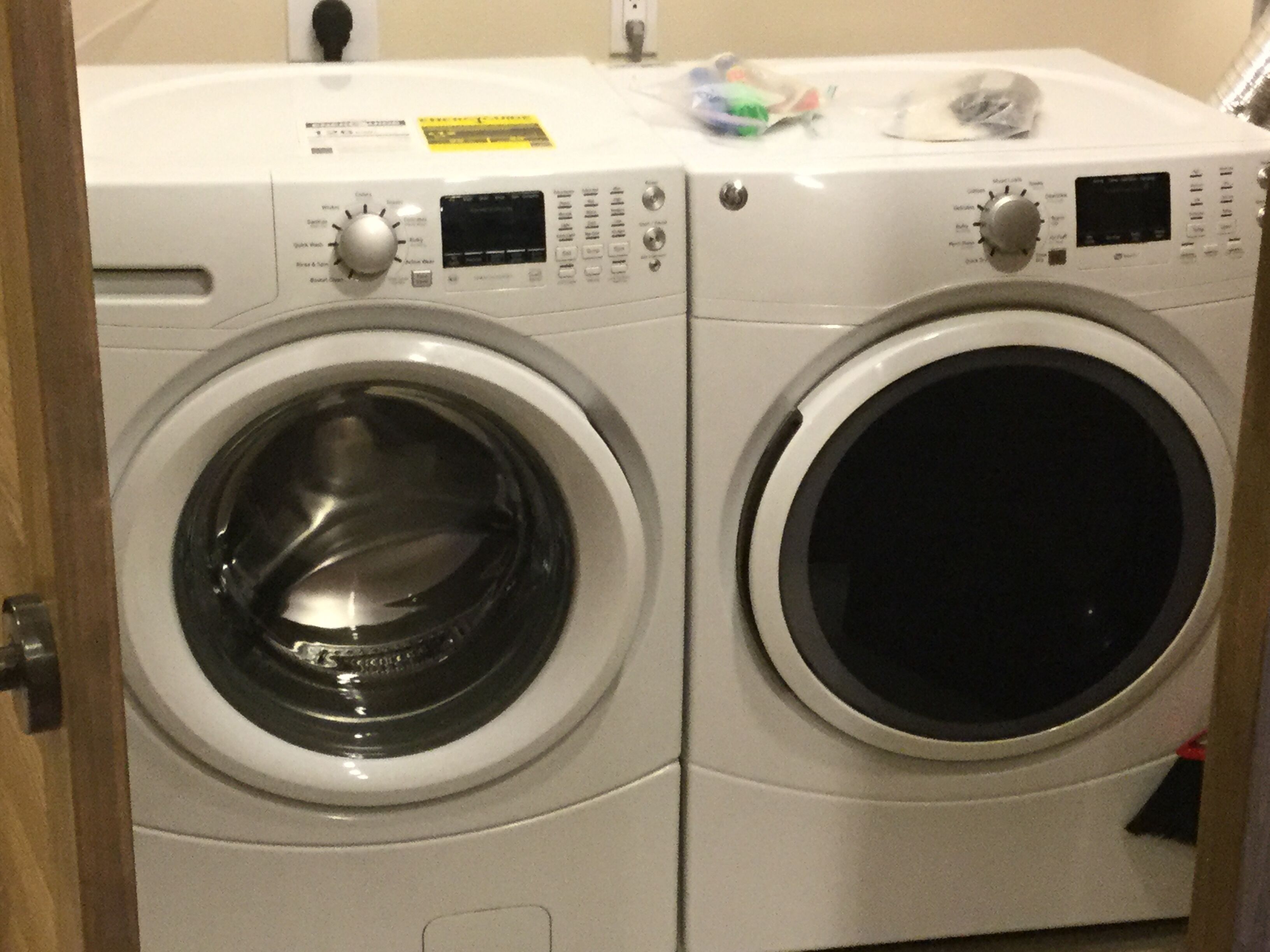Two front-loading washing machines in a laundry room.