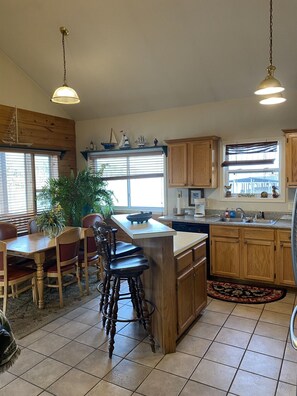 Enjoy cooking in this well-equipped kitchen with a central island, appliances, and ample dining space.