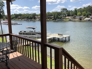 Enjoy a serene lakeside retreat with a dock and seating area overlooking the calm water.