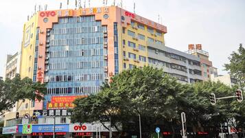 A multi-story building with signage for OYO Inn and a pharmacy.