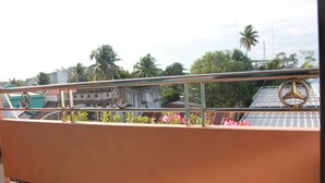 A balcony with metal railings and a Mercedes-Benz logo.