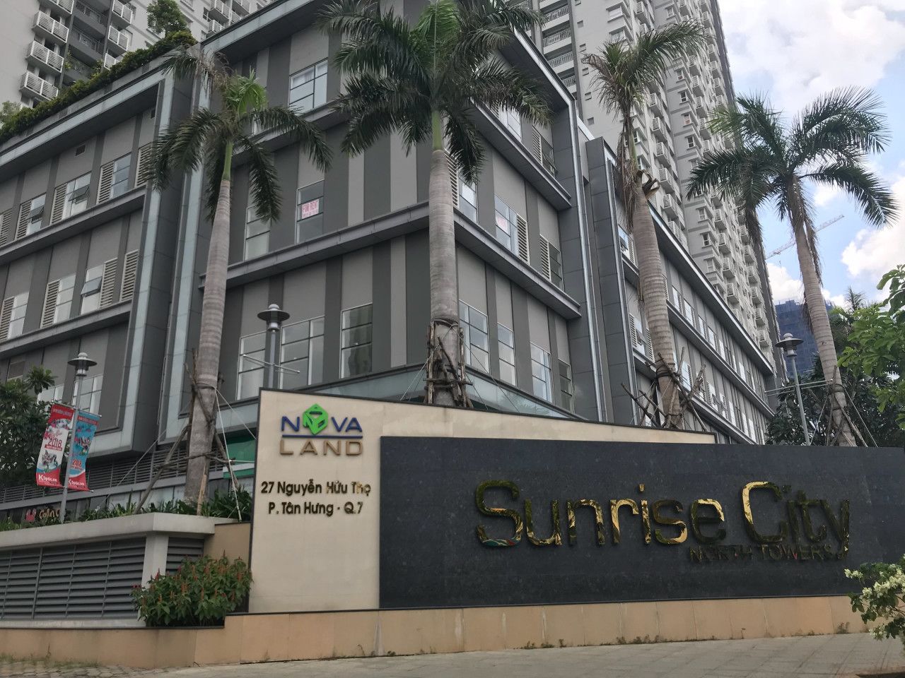 A multi-story building with a sign reading "Sunrise City North Towers" and "Nova Land".