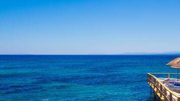 Pantai pribadi, kursi berjemur, dan payung pantai