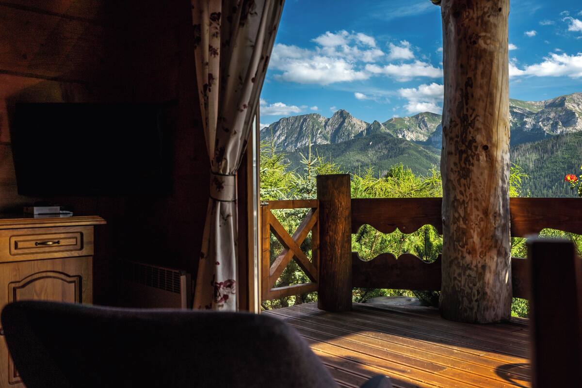 A wooden deck with a view of mountains.