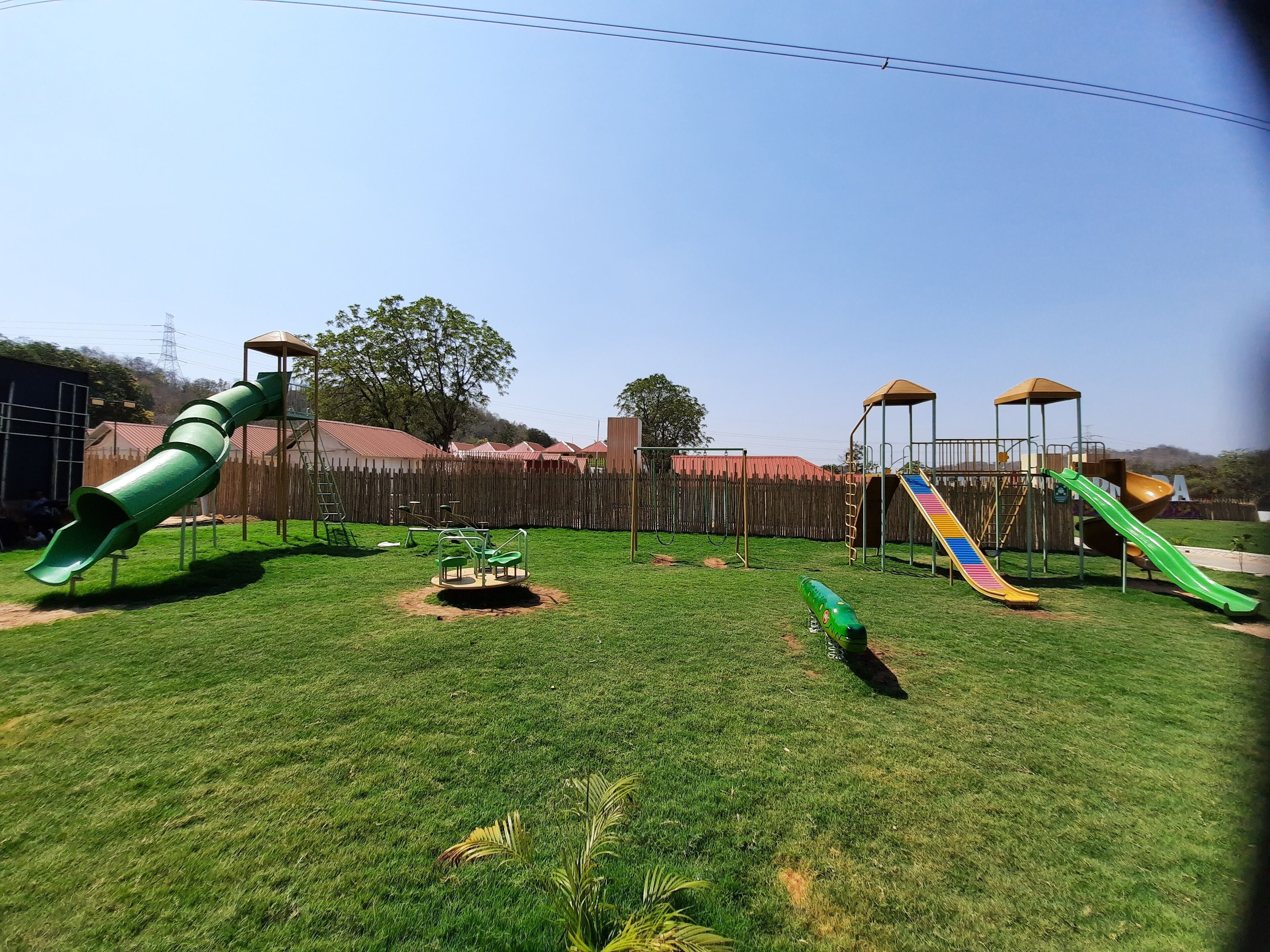 A playground with various play structures including slides and swings.