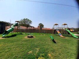 A playground with various play structures including slides and swings.