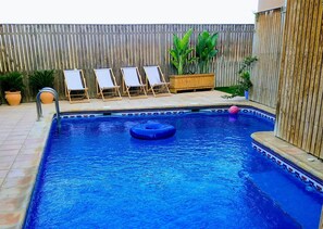 Outdoor pool, open 9:00 AM to 10:00 PM, pool loungers