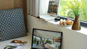 Deluxe Room, Pool View | Minibar, in-room safe, desk, laptop workspace
