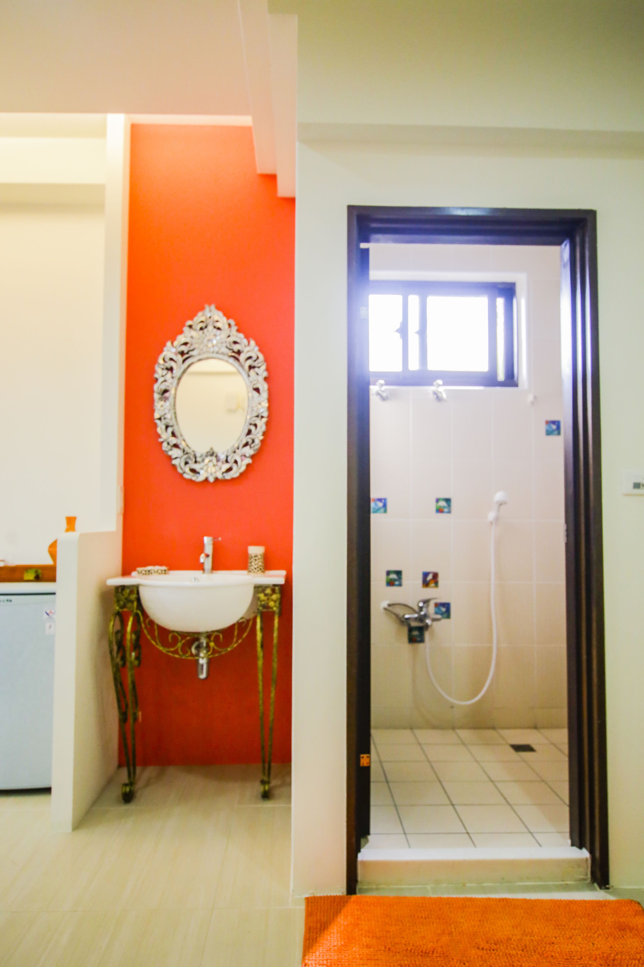 A bathroom with a sink, mirror, and shower.