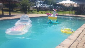 A swimming pool with inflatable toys. - Lalapanzi Hotel and Conference Centre (Louis Trichardt)