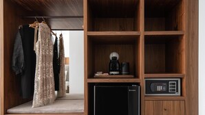 A wooden wardrobe with multiple shelves, a hanging space, and a built-in appliance. - 4-You (Polygyros)