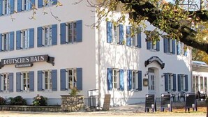 A building with a sign reading "DEUTSCHES HAUS" and a stone facade. - Deutsches Haus (Waal)