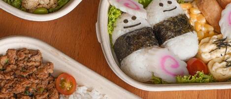 Three bento-style meal containers with various food items.